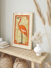 Orange crane bird illustration with black legs and beak, on beige background within an orange, in an alternate framed mockup