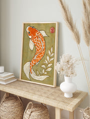 Illustrative orange and white koi fish swimming against an olive green background with a red, in an alternate framed mockup
