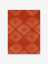 Orange quatrefoil pattern wall art with repeating geometric lattice motifs on a textured background