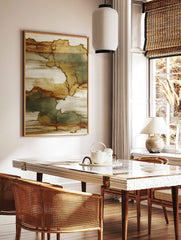 Abstract wall art print with organic shapes in brown, tan, and muted green-grey, on a textured, in a styled room mockup