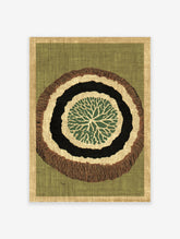 Organic abstract wall art print with green, black, and brown concentric rings, resembling a tree slice, on a green background.