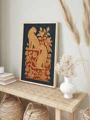 Ornate leopard print with two spotted felines amidst beige and red botanical foliage on a, in an alternate framed mockup