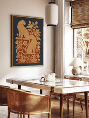 Ornate leopard print with two spotted felines amidst beige and red botanical foliage on a blue, in a styled room mockup