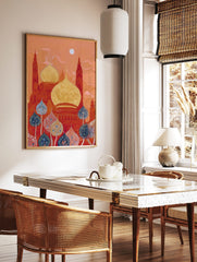 Ornate red and gold mosque domes with tall towers under an orange sky, with blue and red decorative, in a styled room mockup