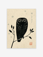 Black owl with white ringed eyes on a branch, beige textured background, blue circles, red seal