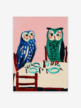 Owl wall art painting featuring two blue and green owls seated at a dining table with a pink background.