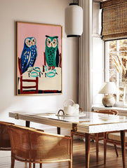 Owl wall art painting featuring two blue and green owls seated at a dining table with a pink background. - Image 2
