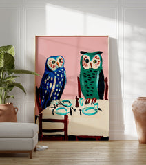 Owl wall art painting featuring two blue and green owls seated at a dining table with a pink background. - Image 3