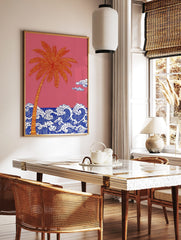 Illustrative palm tree with orange and yellow fronds over blue ocean waves against a pink sky with, in a styled room mockup