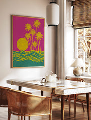 Graphic yellow palm trees, concentric sun, and ornate waves on a pink and teal background, in a styled room mockup