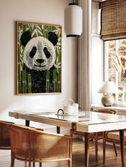 Illustrative linocut style panda bear art print in black, white, and green bamboo forest, in a styled room mockup