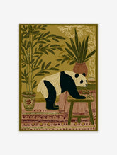 Illustrated panda wall art print in an indoor setting with bamboo plants, a patterned rug, and a stool.