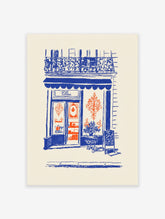 A blue and orange illustration poster of a vintage Parisian shop facade with a cafe, balcony, and street details.