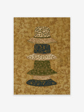 Patterned Hat Wall Art featuring a stack of five decorative hats with botanical and ornate designs on a textured gold background.