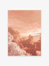 Close-up of voluminous peach and white clouds in a warm sky, appearing dreamy and serene