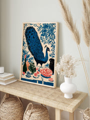 Illustrative blue peacock with fanned tail and still life with fruit, bottle, and vase on a, in an alternate framed mockup