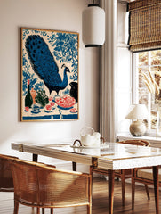 Illustrative blue peacock with fanned tail and still life with fruit, bottle, and vase on a table, in a styled room mockup