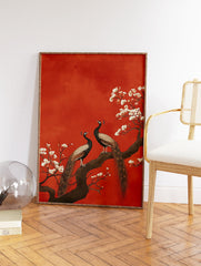 Two peacocks perch on a flowering branch with white blossoms against a textured red background in a traditional art style. - Image 2