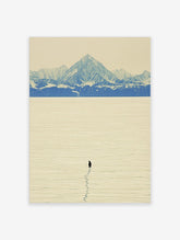 Single penguin with footprints on vast snow plain, blue mountains in background, minimalist landscape art print
