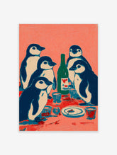Illustrative print of five navy and white penguins at a table with a green bottle and cups on a coral background
