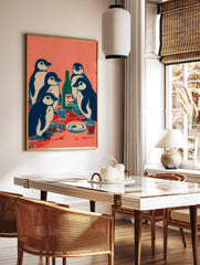Illustrative print of five navy and white penguins at a table with a green bottle and cups on a, in a styled room mockup