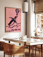Whimsical black ink illustration of a penguin flying while holding a hot air balloon on a pink, in a styled room mockup