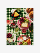Picnic wall art illustration with cheese, grapes, strawberries, bread, and wine on a green checkered tablecloth.