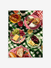 Vibrant picnic wall art illustration with cheese, grapes, bread, and drinks on a green checkered tablecloth