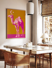 Pop art style print of a pink camel with a crescent moon and star on a golden-orange and magenta, in a styled room mockup