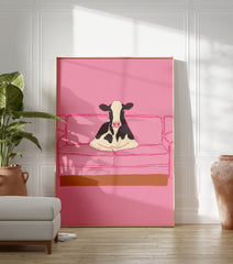 Illustrative art print of a black and white cow sitting on a pink couch, set against a solid pink background. - Image 3