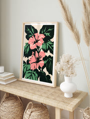 Pink hibiscus flowers with dark green leaves on a light beige background in a bold graphic, in an alternate framed mockup