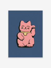 Pink lucky cat wall art with raised paw, yellow bell, and blue background