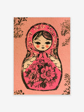 Pink Matryoshka doll illustration with black floral patterns and leaf accents on a matte pink background