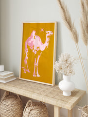 Pink pop art camel with crescent moon on hump and star on golden yellow background, in an alternate framed mockup