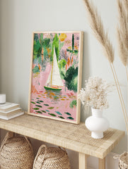 Illustrative sailboat on a pink river with green foliage and colourful fish art print, in an alternate framed mockup