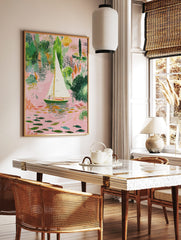 Illustrative sailboat on a pink river with green foliage and colourful fish art print, in a styled room mockup