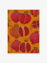 Vibrant pomegranate wall art print with botanical illustrations of whole and cut pomegranates on an orange background.