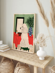 Illustrative art print of a white poodle sitting on a green stool before a mirror on a red, in an alternate framed mockup