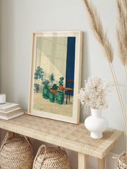 Potted plants in ceramic and terracotta pots with a wooden chair and blue wall stripe in a, in an alternate framed mockup