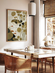 Illustrative puffer fish wall art with spiky body, orange eye, olive plants, and small orange fish, in a styled room mockup
