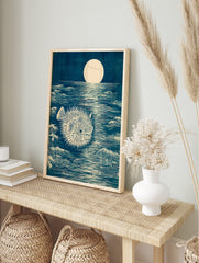 Japanese woodblock style art print of a spiky pufferfish in a dark blue moonlit ocean with, in an alternate framed mockup