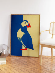 Graphic puffin wall art illustration in blue, yellow, and red on textured paper. - Image 2