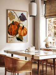 Pumpkin wall art featuring two orange gourds and botanical vines on a cream background, in a styled room mockup