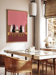 Illustrative print of five black and white rabbits playing cards at a green table on a pink, in a styled room mockup