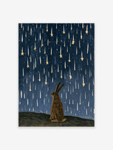Illustrative rabbit silhouette gazing up at falling golden stars against a textured deep blue night sky art print