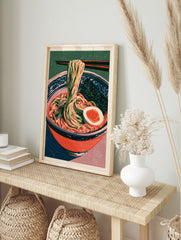 Ramen bowl art print with noodles, egg, and nori in a red bowl against a green background, in an alternate framed mockup