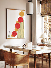 Abstract art print with vertical stack of red and yellow textured circles on cream background with, in a styled room mockup
