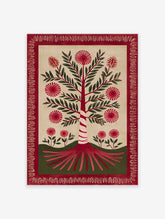 Red botanical tree folk art print with green leaves and spiky red flowers, surrounded by a red decorative border on a cream background.