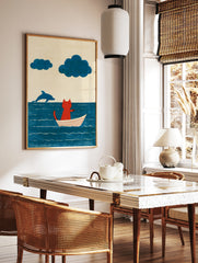 Illustration of a red cat sitting in a white boat on a blue sea with a jumping dolphin and two blue, in a styled room mockup