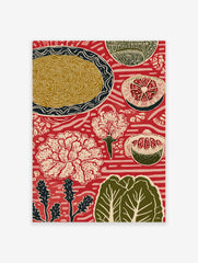 Red folk art print with plate of noodles, sliced grapefruit, pomegranate, and white flowers on patterned background